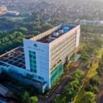 Discover the contemporary architecture of Eka Hospital from an aerial perspective, surrounded by lush greenery in Serpong, Indonesia.