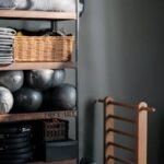 Neat arrangement of gym equipment and yoga mats in a modern fitness studio.